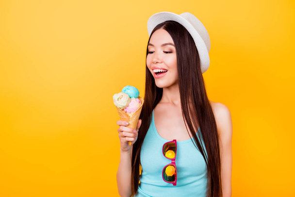 Cheerful young korean lady looks at tasty ice cream of three sco - Φωτογραφία, εικόνα
