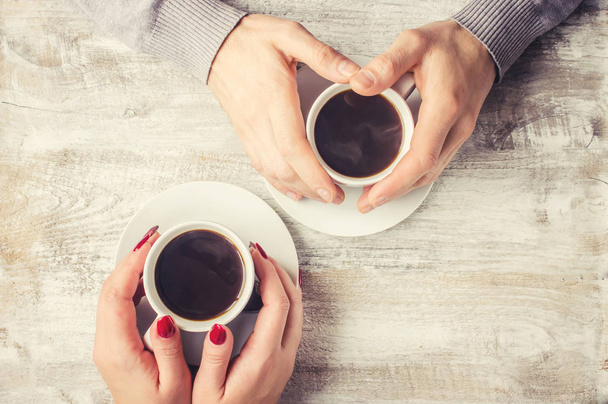 lovers holding together a Cup of tea. Selective focus.  - Photo, Image