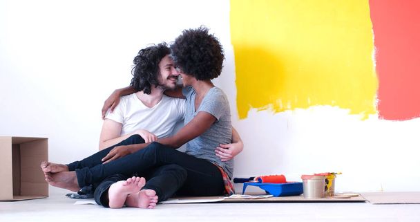 young multiethnic couple relaxing after painting - Фото, зображення