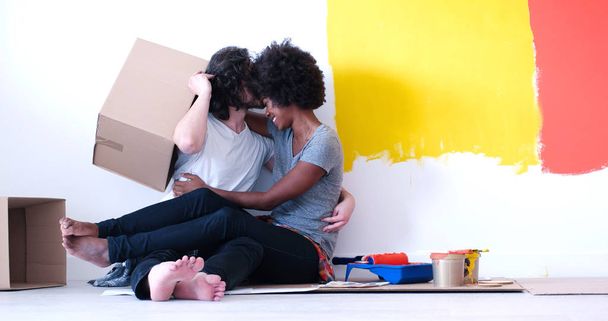 young multiethnic couple playing with cardboard boxes - Photo, Image