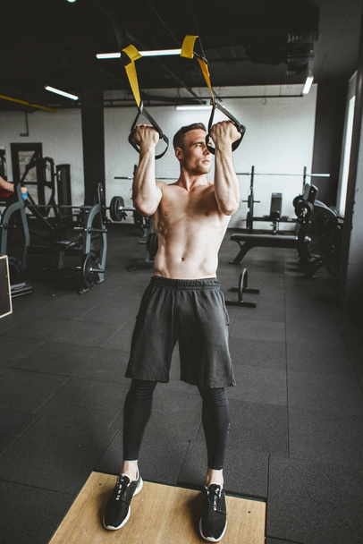 Man in sportswear exercising at gym - Photo, Image