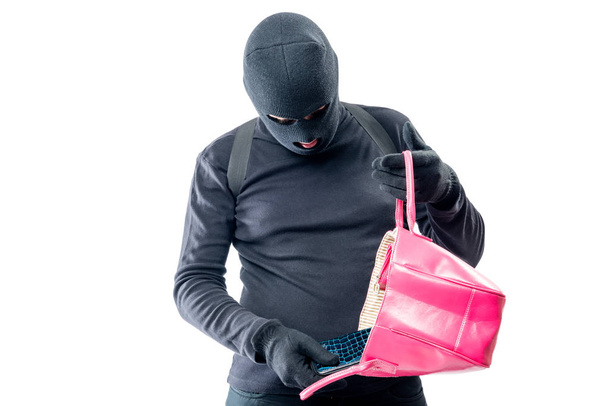 Robber tira fuori una borsa da una borsa femminile su uno sfondo bianco
 - Foto, immagini