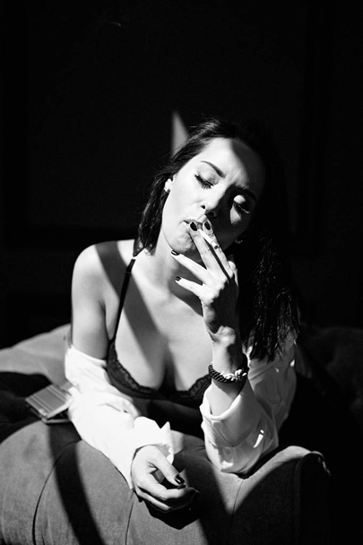young woman in bra and shirt smoking - Zdjęcie, obraz