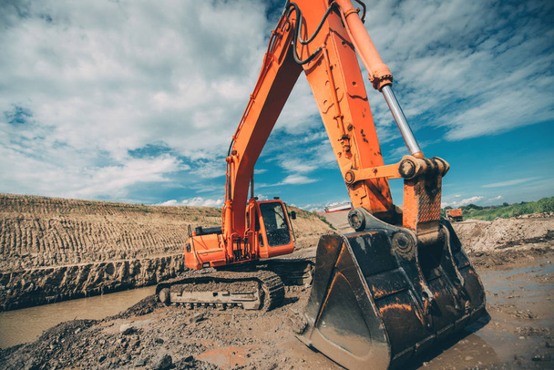 Heavy machinery, industrial excavator digging for viaduct construction during highway roadworks - Fotó, kép