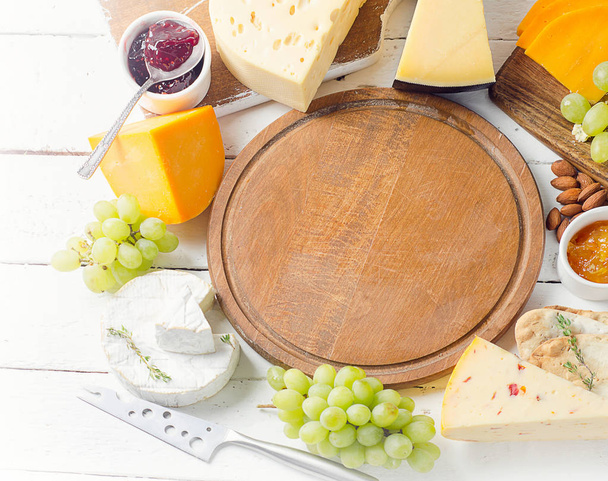 Assorted cheeses served with grapes - Photo, image