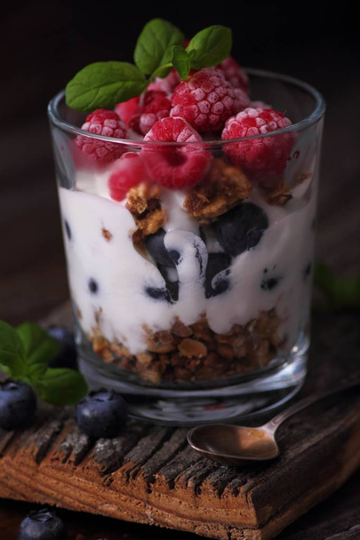Granola with frozen fruits in yogurt - Фото, изображение