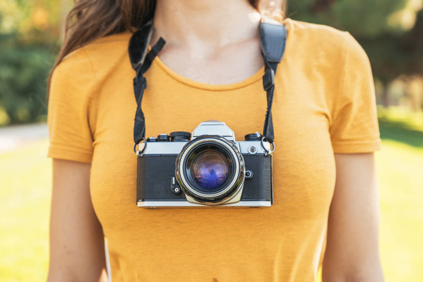 Close up of a photographer with her camera. - Foto, afbeelding