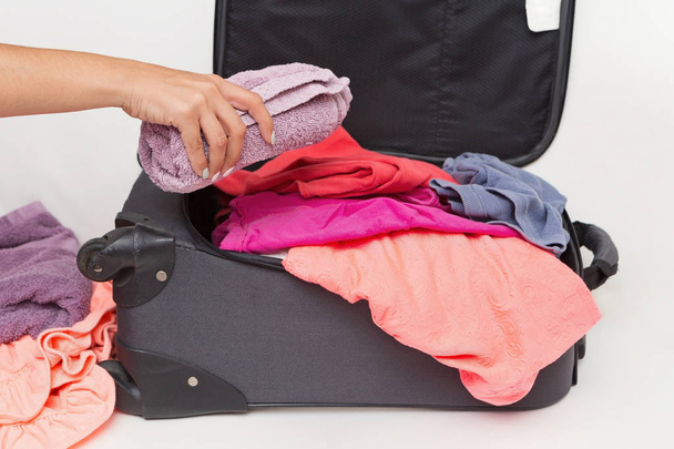 Woman Packing Her Carry on with Clothes - Foto, afbeelding