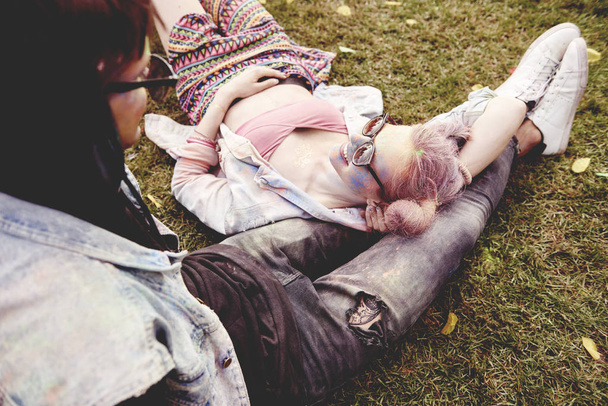 Couple relaxing on the grass before the concert  - Valokuva, kuva