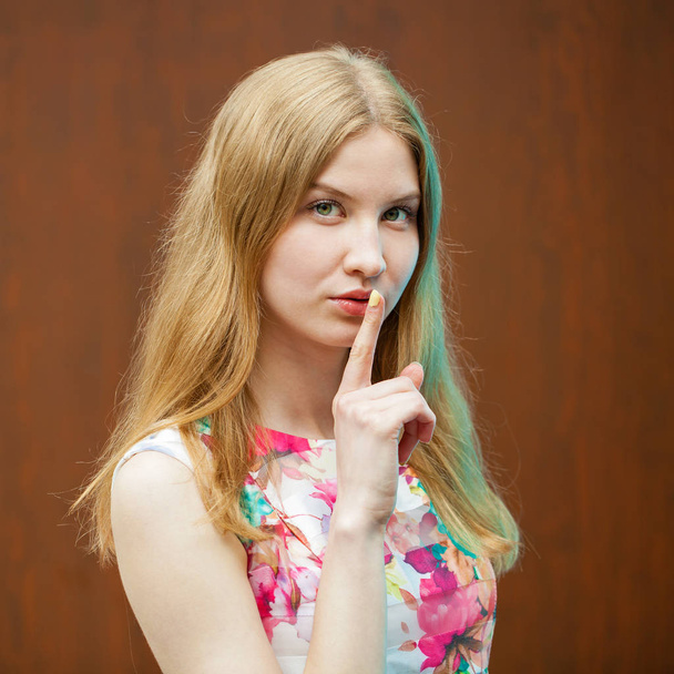 Young beautiful blonde woman has put forefinger to lips as sign  - Φωτογραφία, εικόνα