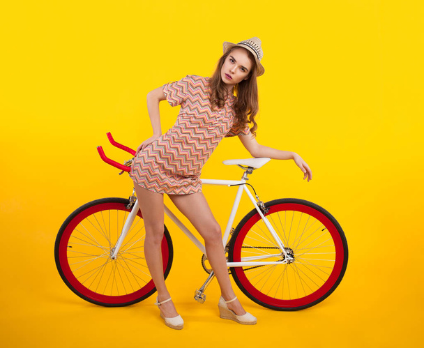 Serious girl posing with bicycle - Zdjęcie, obraz