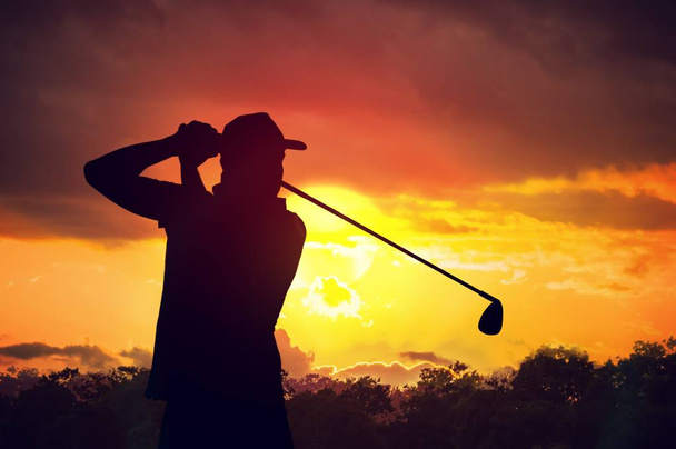 Σιλουέτα του ανθρώπου παίζει γκολφ στο ηλιοβασίλεμα. - Φωτογραφία, εικόνα
