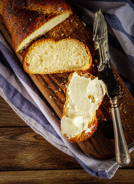 Sliced Hala with butter is a traditional Jewish sweet fresh sabb
 - Фото, изображение