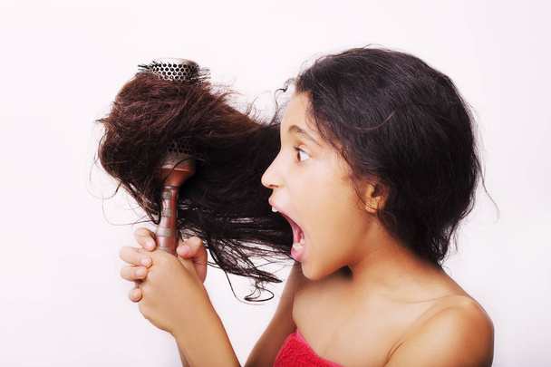 Hair care concept with portrait of girl brushing her unruly - Foto, imagen