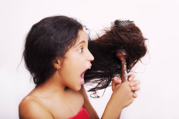 Hair care concept with portrait of girl brushing her unruly - Foto, imagen