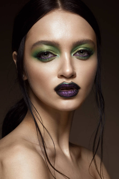 Beautiful girl with spring green makeup and vampire lips. beauty face. - Photo, Image