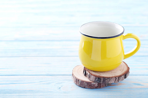 Yellow empty mug  - Фото, изображение