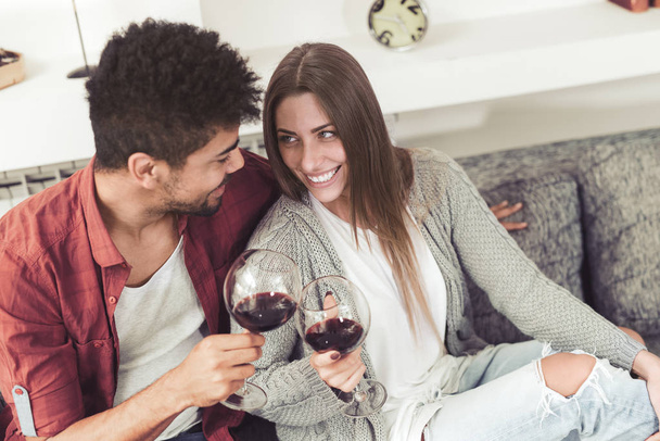 Beautiful couple  drinking wine,talking and smiling. - Foto, Bild