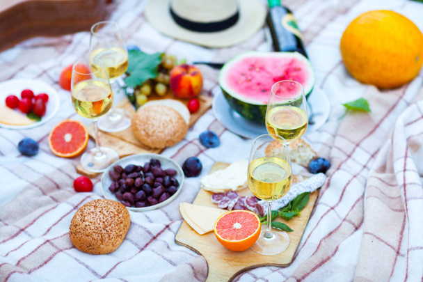 Summer Picnic Basket on the Green Grass. Food and drink concept. - Фото, изображение