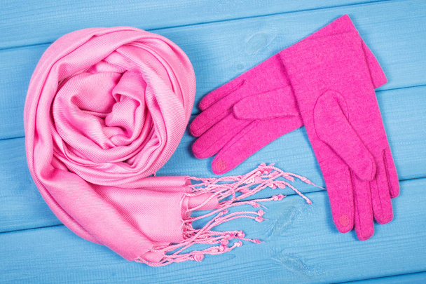 Woolen gloves and shawl on blue boards, womanly clothing for autumn or winter - Foto, Imagem