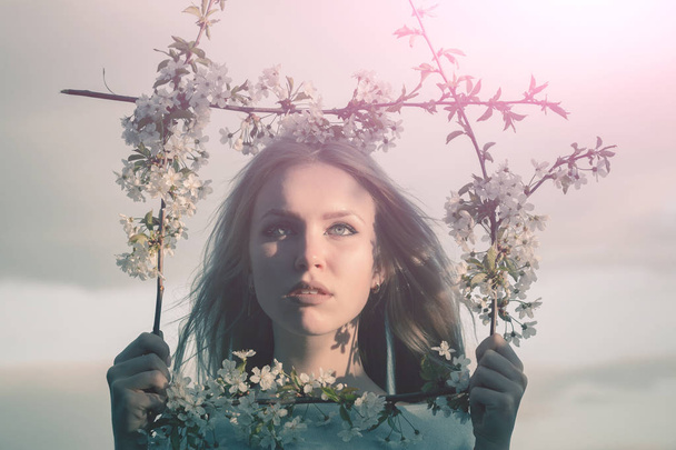 Woman in blossoming flower. - 写真・画像