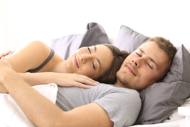 Happy couple sleeping together on a bed - Фото, зображення