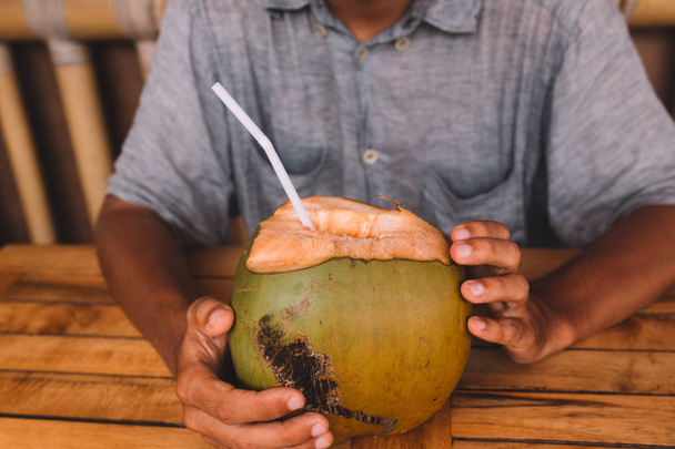 man drinking coconut milk - Fotoğraf, Görsel