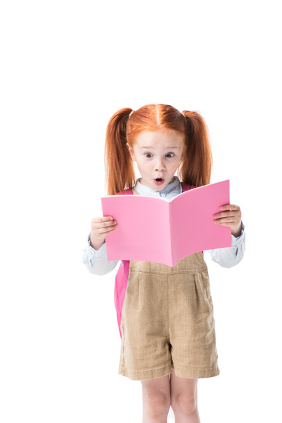 Surprised schoolgirl with book - Valokuva, kuva