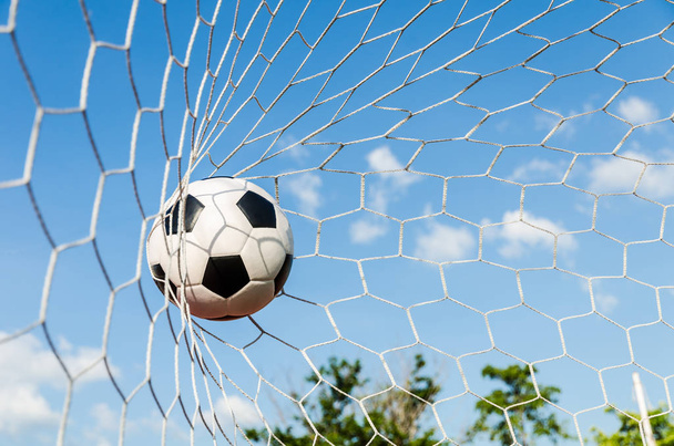 Soccer football in Goal net with the sky field. - Photo, Image
