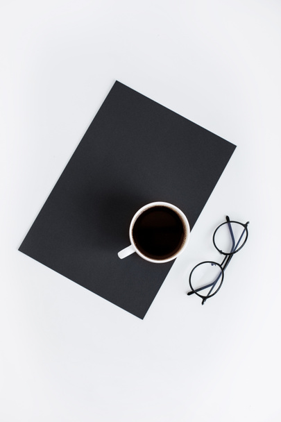 cup of coffee on black paper  - Zdjęcie, obraz