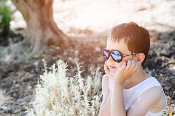 Sad little child boy wearing sunglasses - Photo, Image