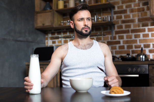 thoughtful man with milk at breakfast - Photo, Image