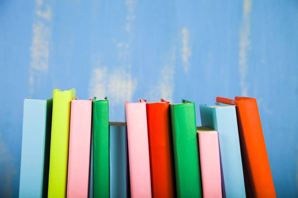 Stack of books on a blue background.  - Photo, image