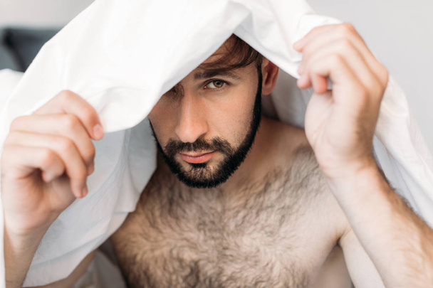handsome shirtless man under blanket - Фото, зображення