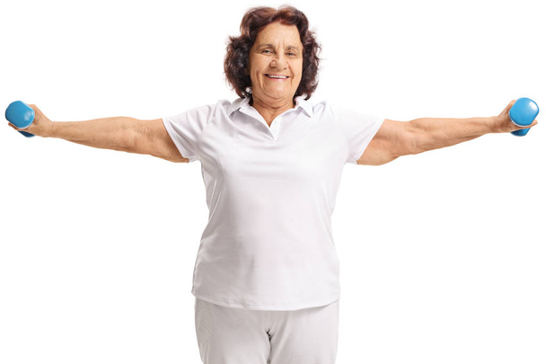 Elderly woman exercising with small dumbbells - Фото, зображення