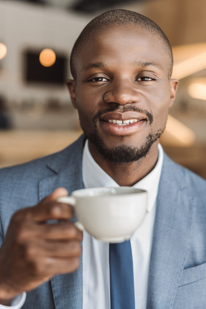 businessman with cup of coffee in cafe  - Zdjęcie, obraz