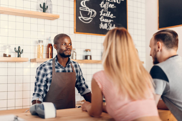 barista talking with clients  - Photo, Image
