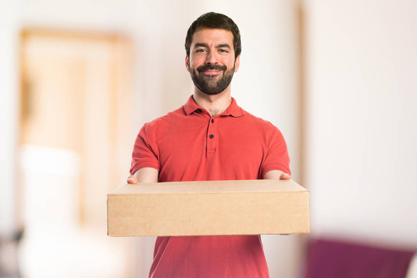 Handsome man holding boxes - Фото, зображення