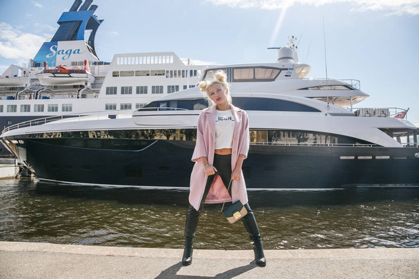 Blond woman standing in port - Photo, Image