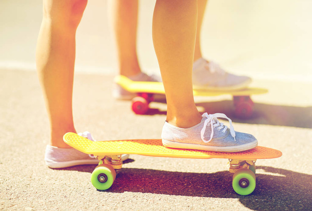 close up of female feet riding short skateboard - Fotoğraf, Görsel