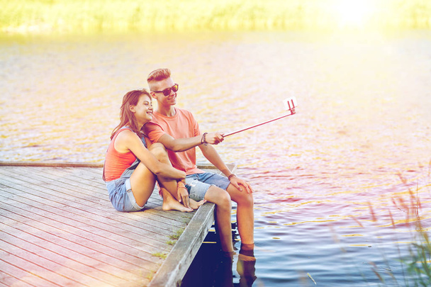 happy teenage couple taking selfie on smartphone - Fotoğraf, Görsel