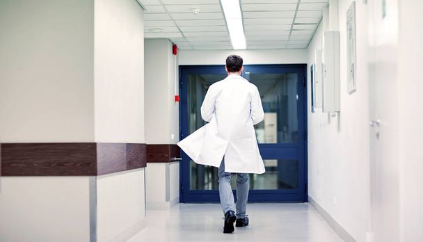 medic or doctor walking along hospital corridor - Zdjęcie, obraz