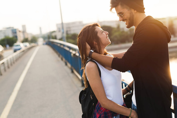 Picture of young attractive couple carrying skateboards - Photo, image