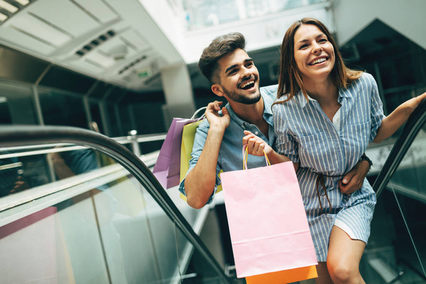 Happy attractive loving couple enjoy shopping together - Photo, Image