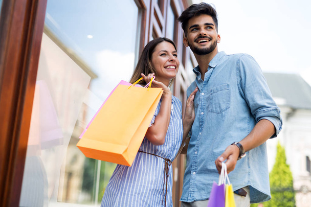 Happy attractive loving couple enjoy shopping together - Photo, Image