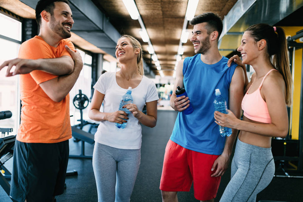 Picture of cheerful fitness team in gym - Фото, зображення