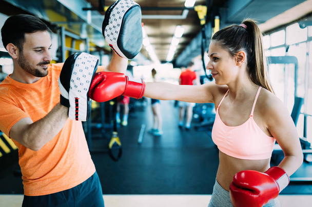 Picture of woman boxing with her trainer - Фото, зображення
