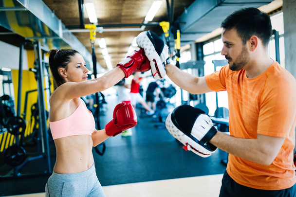 Picture of woman boxing with her trainer - Фото, зображення