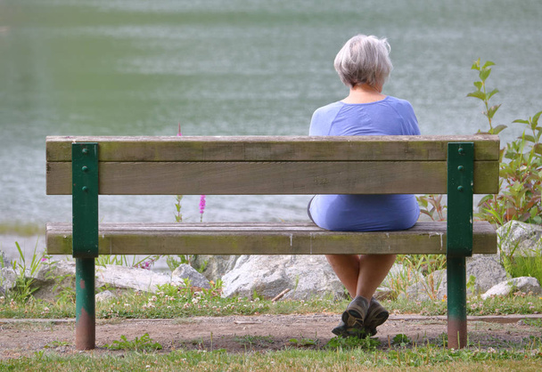 Senior Woman on Park Bench - Фото, изображение