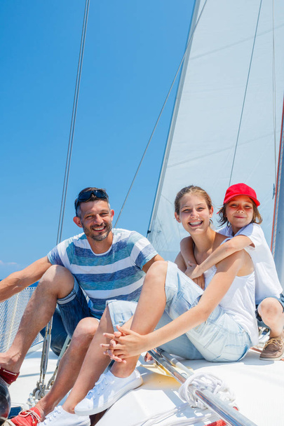 Father with adorable kids resting on yacht - Foto, immagini